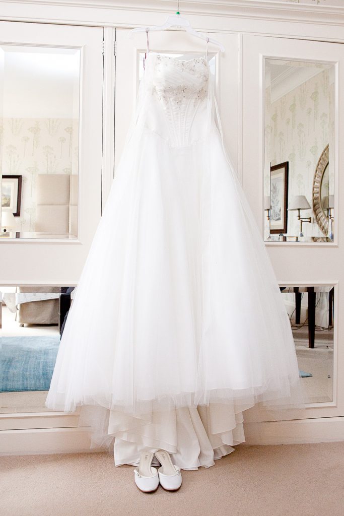 Stunning Wedding Dress hanging on the wardrobe waiting for the Bride. 