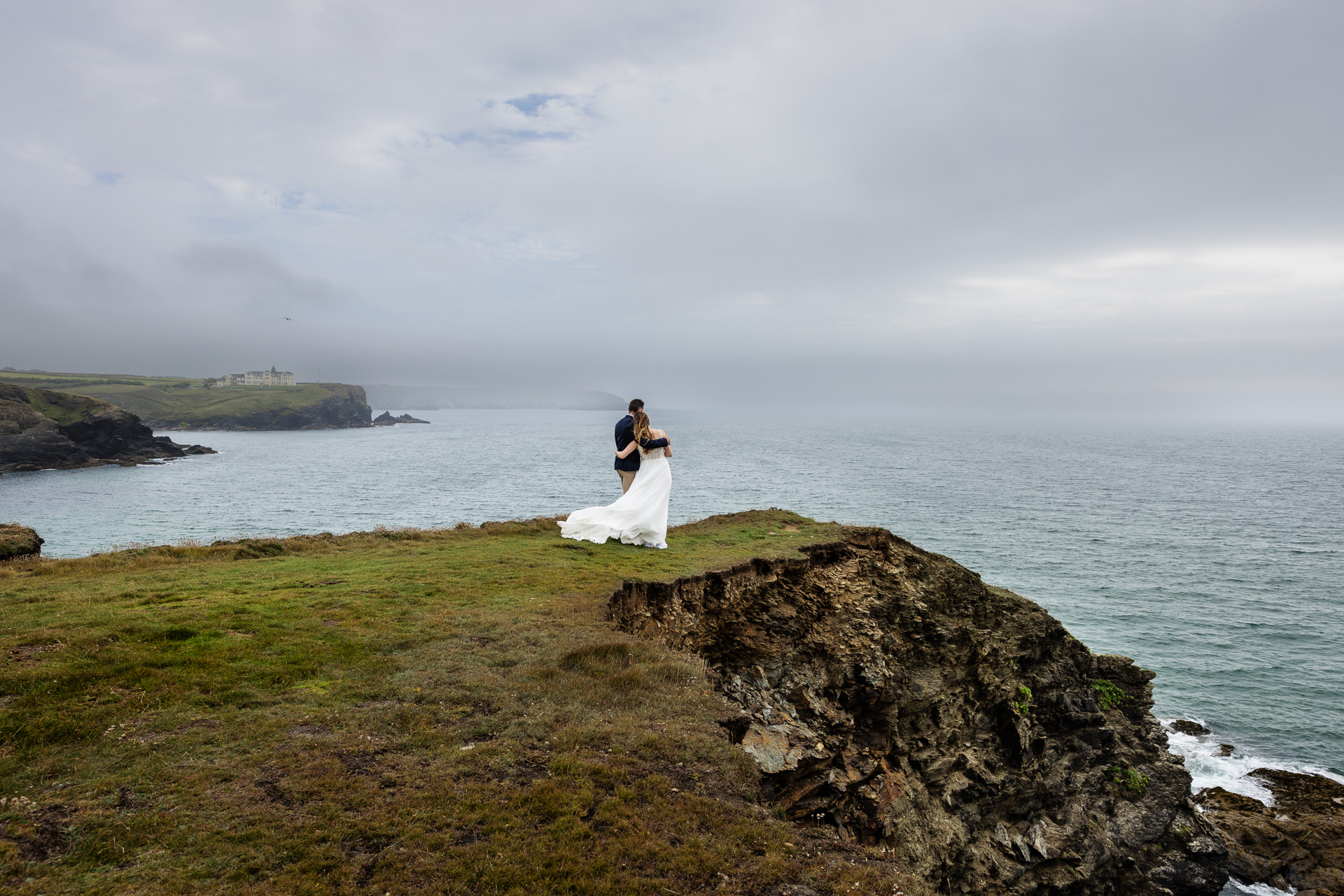Incredible Wedding Photos of Bride & Groom on cliff top at Gunwalloe with the sea mist rolling in. 