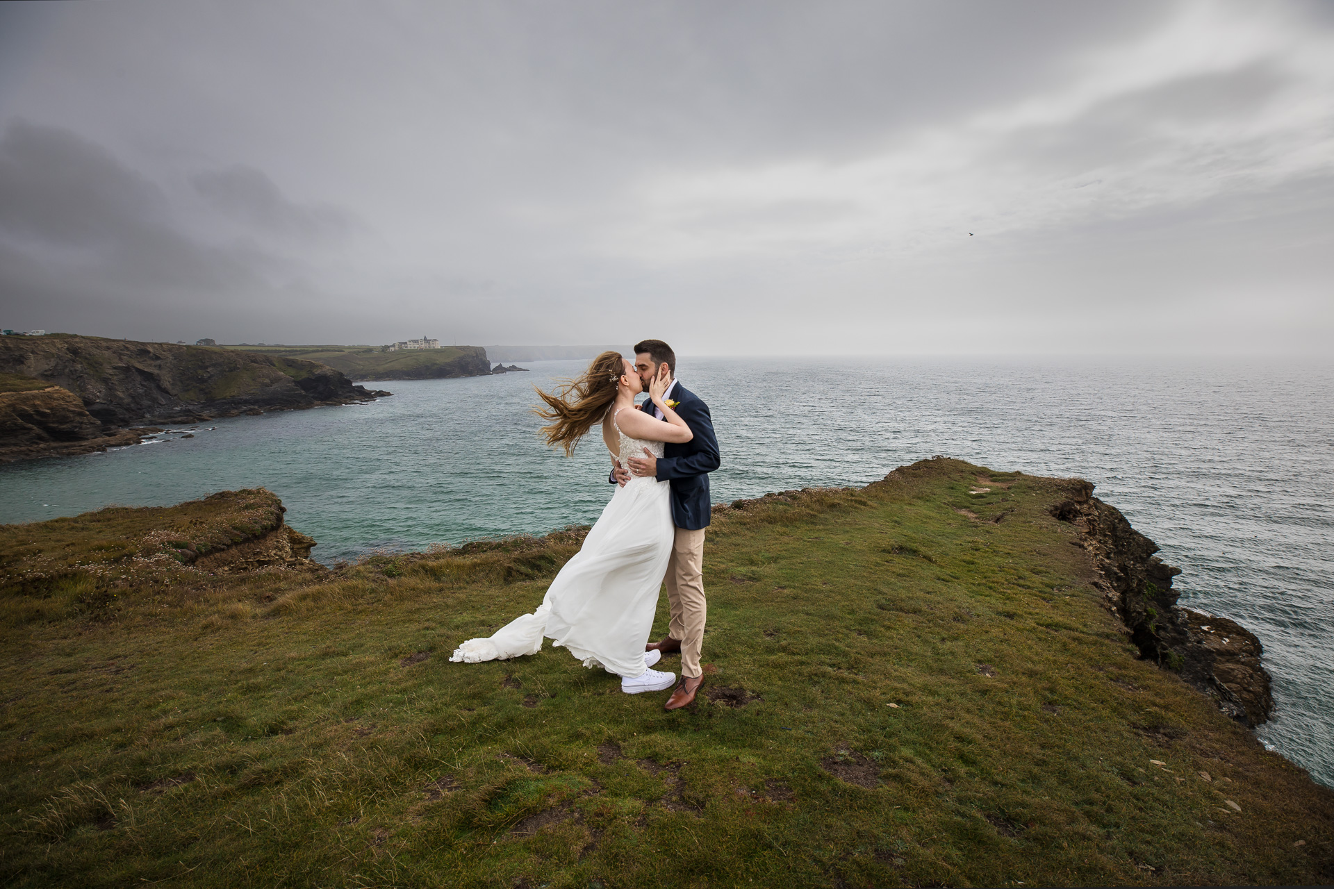Incredible Wedding Photos of Bride & Groom on cliff top at Gunwalloe with the sea mist rolling in. 