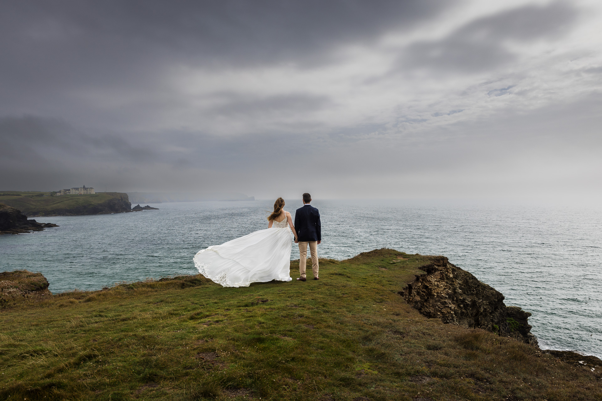 Incredible Wedding Photos of Bride & Groom on cliff top at Gunwalloe with the sea mist rolling in. 