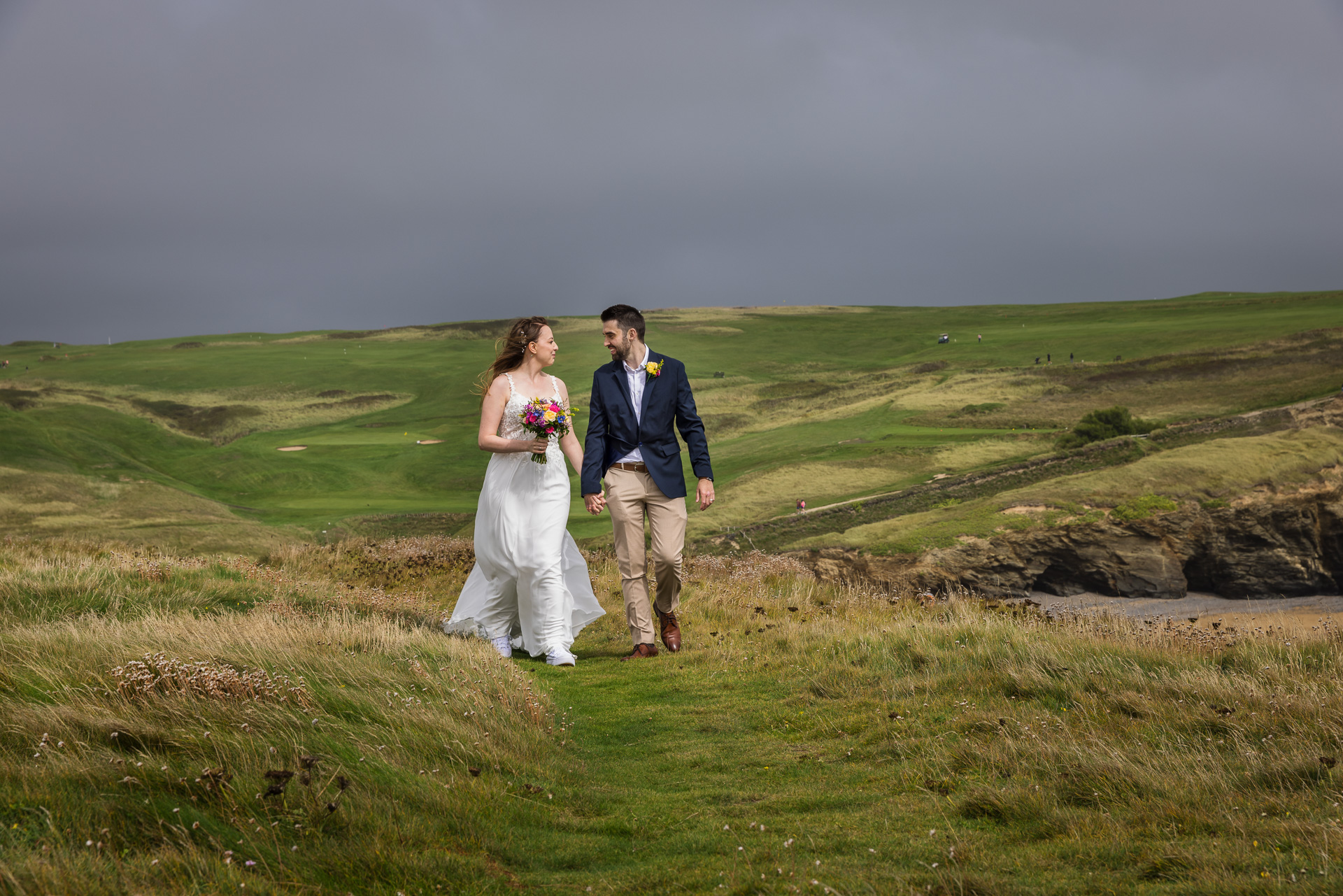 Bride & Groom at Gunwallow Church with Mullion Golf Course in the Background