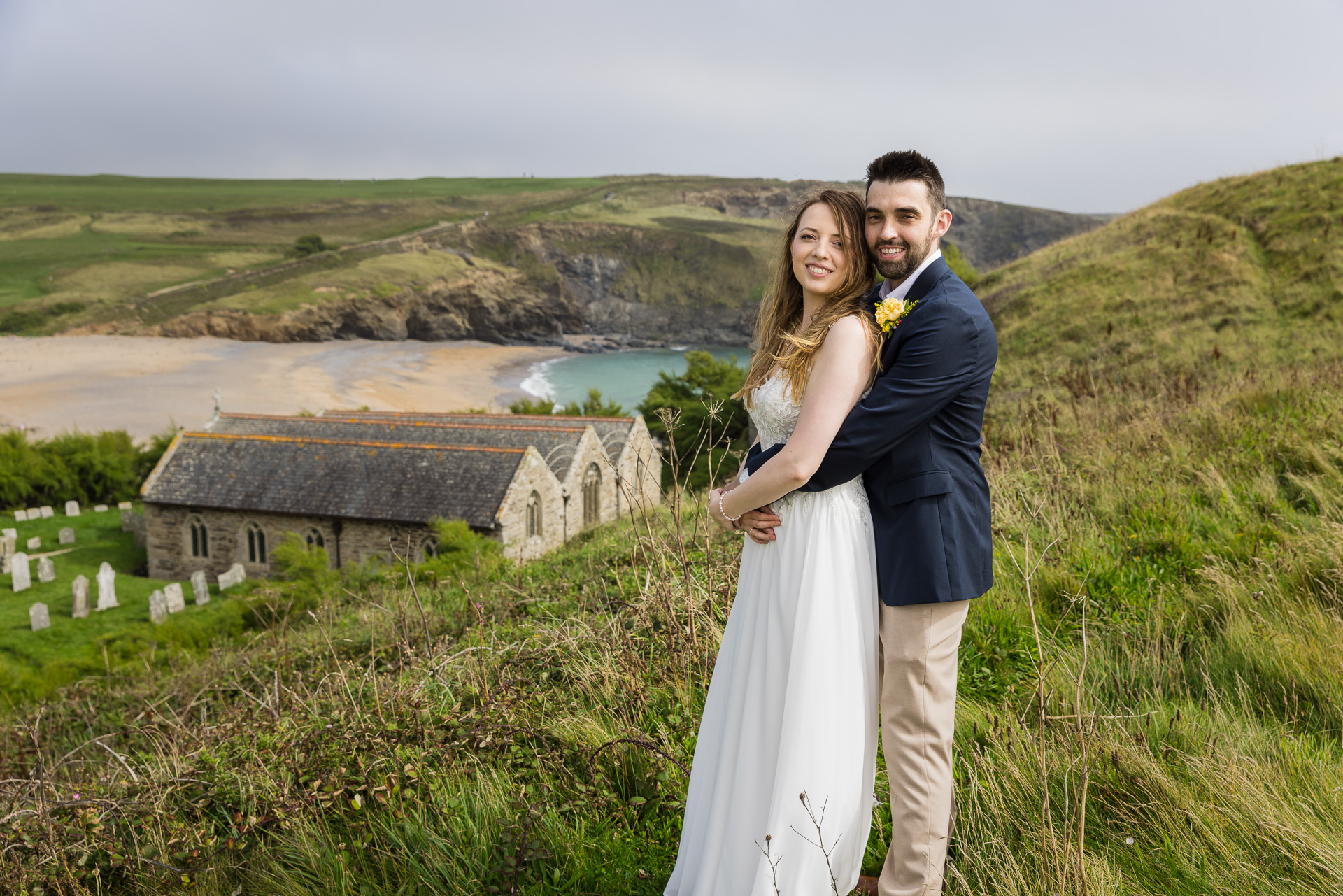 Wedding Photography of the Bride & Groom with Gunwalloe Church and the Beach in the background.