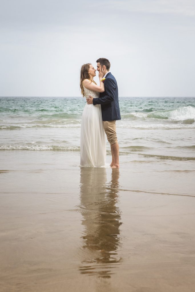 Bride & Groom in the Sea at Kynance Cove on the Lizard in Cornwall following their elopement Wedding at Gunwalloe