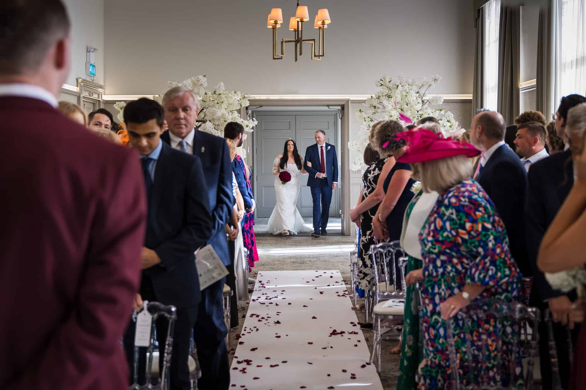 The groom first sets his eye's on his bride as she walks down the aisle at the De Vere Beaumont Estate in Windsor. 